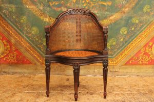 Fauteuil de bureau canné dit  'Couillard' en merisier laqué noir, époque Louis XVI